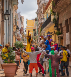 Cubans natives gathering in the street for celebration with vacation travelers