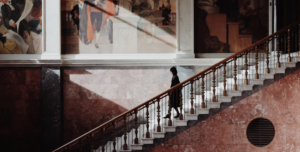 FEMALE TOURIST ON VACATION SEEN WALKING DOWN A FLIGHT OF STAIRS AT ONE OF SWEDEN'S FAMOUS MUSEUMS