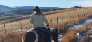 DUDE RANCHER RIDING A HORSE